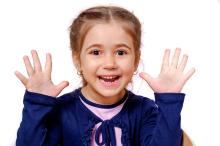 Body Awareness child holding all ten fingers up, representing her understanding of body awareness