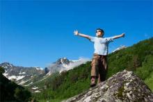 child on a mountain displaying confidence