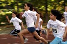 Group of cross county youth athletes running, symbolizing Endurance