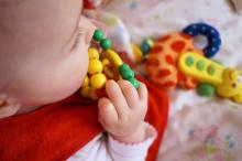 young child in the sensorimotor stage playing with sensory toys