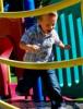 Mobility child running across a playground bridge, symbolizing their mobility