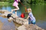 Children participating in Free Play near water