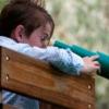 child utilizing their visual perception with a playground telescope